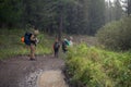 Tourists in the rain on the muddy country road, Altai mountains, Russia Royalty Free Stock Photo