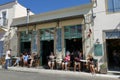 Tourists relax at the historic Asticon bar in Potamos, Greece
