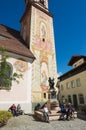 Tourists relax next to the statue of Matthias Klotz the world famous violin maker in Mittenwald, Germany.