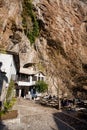 Tourists relax in outdoor cafe near historic Sufi monastery Blagaj Tekke in mountains