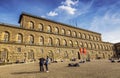 Tourists relax on the square in front of Palazzo Pitti, Florence,