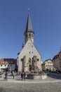 tourists relax at the town central square of Weikersheim along the romantic road