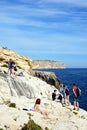 Tourists relaxing at Blue Grotto, Malta.