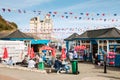 Tourists relaxing eating food, taking a leisurely stroll along Llandudno Pier Royalty Free Stock Photo