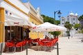 Pavement cafe and church, Castro Marim. Royalty Free Stock Photo