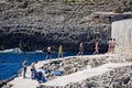 Tourists relaxing on the rocks, Blue Grotto.
