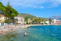Tourists rest on beach of beautiful promenade of Tivat, Montenegro