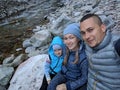 Tourists rest after hike and take selfie on the phone. Photos from the phone during the hike. Family travels. People