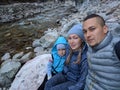 Tourists rest after hike and take selfie on the phone. Photos from the phone during the hike. Family travels. People Royalty Free Stock Photo