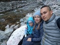 Tourists rest after hike and take selfie on the phone. Photos from the phone during the hike. Family travels. People Royalty Free Stock Photo