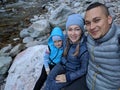 Tourists rest after hike and take selfie on the phone. Photos from the phone during the hike. Family travels. People Royalty Free Stock Photo