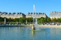 Tourists rest near Grand Bassin Rond fountain in Tuileries Garden, Paris, France Royalty Free Stock Photo