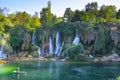 Tourists rest on the waterfall Kravica in Bosnia and Herzegovina