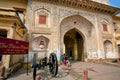 Tourists resting at the entrance gate of City Palace with old cannons