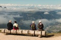 Tourists resting on wooden bench