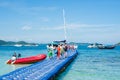 Tourists return from the Banana beach of Coral Ko He island and go to the motor boat. Phuket, Thailand