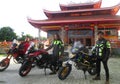 The tourists ride big motor bikes with the background of a pagoda orship place,Blora Central Java.