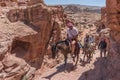 Tourists ride on donkeys to Ad-Deir Monastery in Petra, Jordan. Travel photo