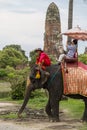 Tourists ride on an elephant in the Historical Park in Ayutthaya, Thailand Royalty Free Stock Photo