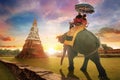 Tourists Ride an Elephant at Wat Chaiwatthanaram temple in Ayuthaya, Thailand Royalty Free Stock Photo