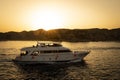Tourists ride on a two-story yacht on the red sea against backdrop of a bright sunset. Sharm el Sheikh Egypt Royalty Free Stock Photo