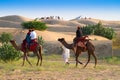 Tourists riding camels, Camelus dromedarius, sand dunes of Thar desert. Camel riding is a favourite activity amongst all Royalty Free Stock Photo
