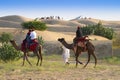 Tourists riding camels, Camelus dromedarius, at sand dunes of Thar desert. Camel riding is a favourite activity amongst all Royalty Free Stock Photo