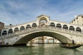 Tourists riding on gondola close to Ponte Rialto bridge on Canal Grande in Venice, Italy Royalty Free Stock Photo