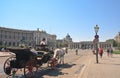 Tourists riding horse-drawn carriage. Hofburg in Vienna, Austria