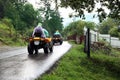 Tourists riding quad bike on road