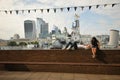 Tourists on river Thames , in front of the royal navy ship HMS Belfast