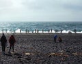 Tourists in the rocky beach of Snaefellsnes, Iceland