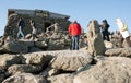 Tourists among the rocky landscape by Tip-Top House on peak of Mount Washington, New Hampshire