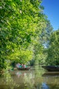 Tourists in a rowboat on a water canal visiting the Green Venice in the Marais Poitevin France