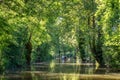 Tourists in a rowboat on a water canal visiting the Green Venice in the Marais Poitevin France Royalty Free Stock Photo