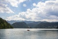 Tourists on a rowing boat in front of Blejsko ostrvo, bled island,