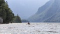 Tourists rowing on a canoe on Bohinj lake in Slovenia