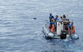 The tourists on the rubber boat see a dolphin