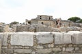 Tourists among ruins of palace Knossos archeological site on Crete