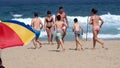 Tourists running on a beach