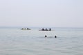 Tourists sail in kayaks on the sea around an island in the Black Sea