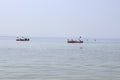 Tourists sail in kayaks on the sea around an island in the Black Sea