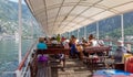 Tourists sail on the pleasure ship admiring the beauty of the Boka Kotorska bay on a warm sunny summer day