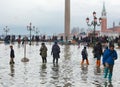 Tourists in San Marco square with high tide, Venice, Italy. Royalty Free Stock Photo