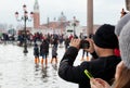 Tourists in San Marco square with high tide, Venice, Italy. Royalty Free Stock Photo