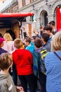 Tourists school kids standing near the fast food kiosk, voting who wants to get hot dog or other tasty but not healthy dish or Royalty Free Stock Photo