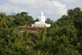 Tourists at a sculpture of the sitting Buddha on Ambasthala mountain. Mikhintale, Sri Lanka Royalty Free Stock Photo