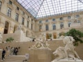 Tourists among the sculptures exhibited at the Louvre Museum in Paris