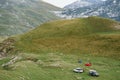 Tourists set up a car camp in the mountains, on the green grass. Montenegro, Durmitor National Park.