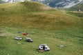 Tourists set up a car camp in the mountains, on the green grass. Montenegro, Durmitor National Park.